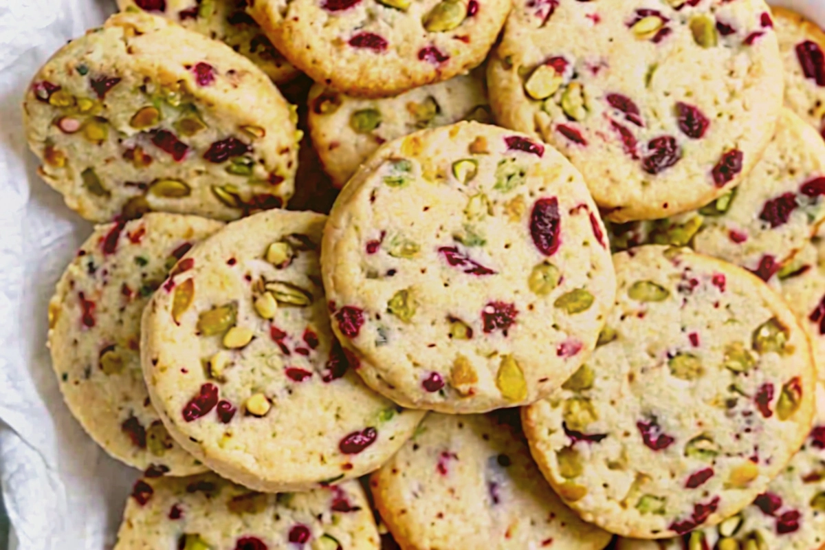 Stack of cranberry & pistachio shortbread cookies on parchment