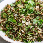 Bowl of Cypriot Grain Salad with freekeh, herbs, nuts, and pomegranate seeds