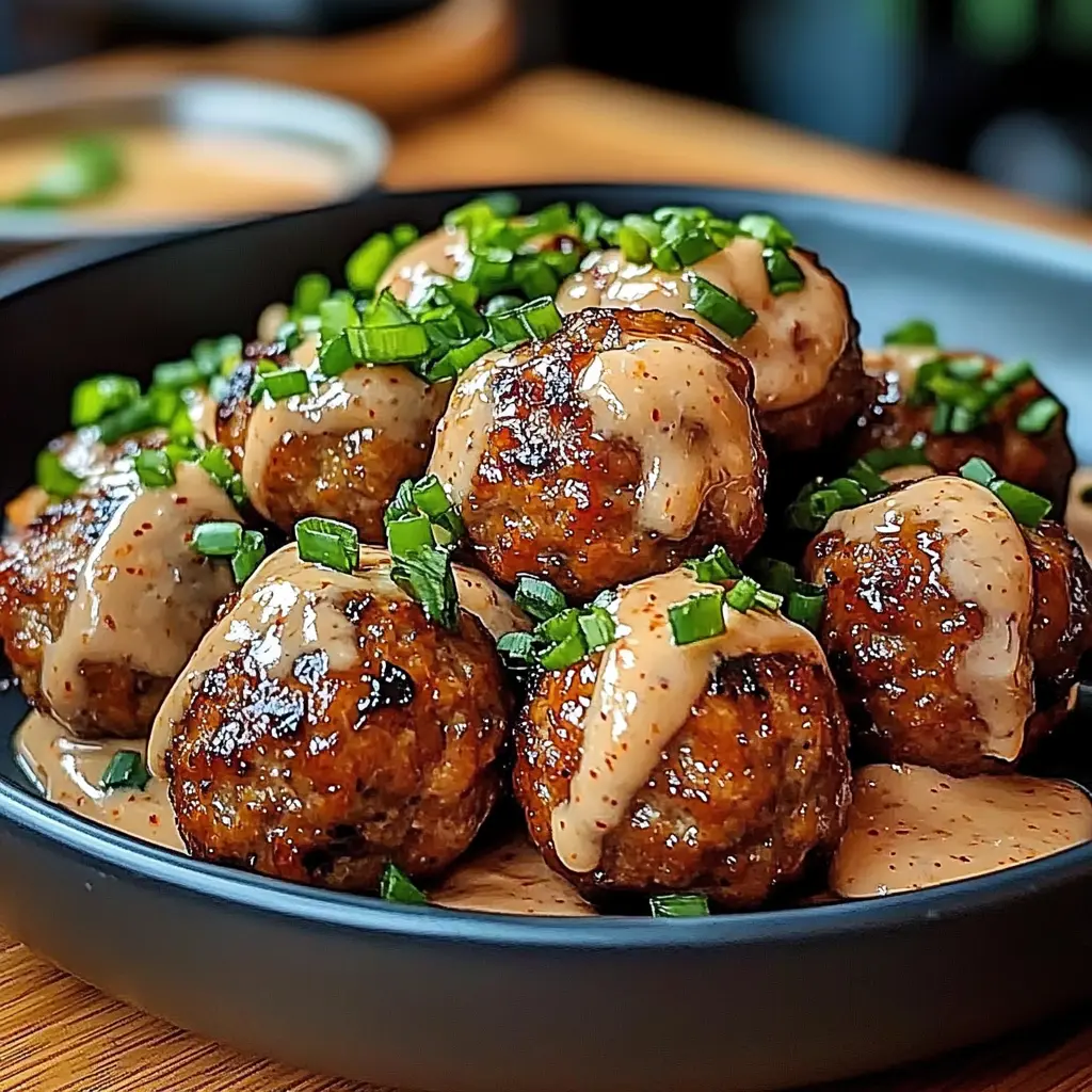 Korean BBQ meatballs glazed in sauce with a bowl of spicy mayo dip
Korean BBQ Meatballs with Spicy Mayo Dip