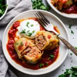 Stuffed cabbage rolls topped with rich tomato sauce