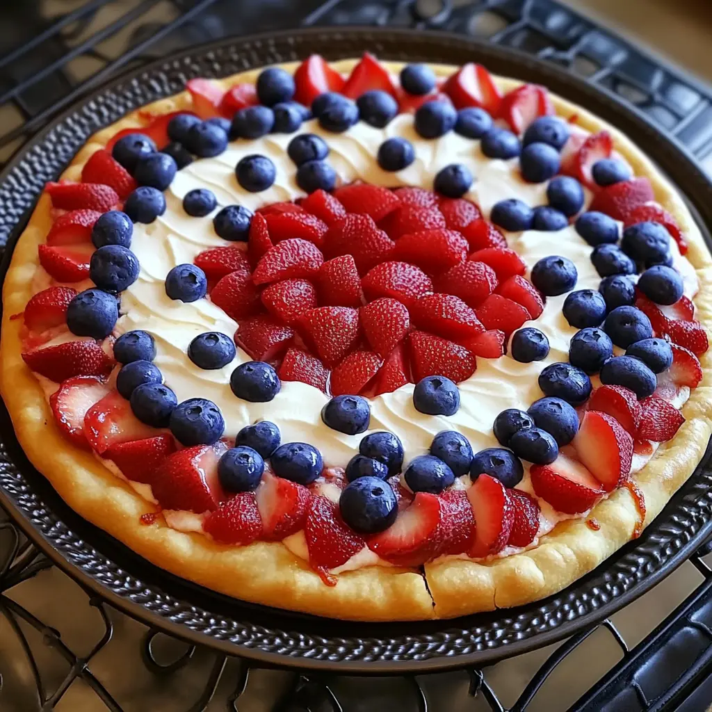 Red White and Blue Fruit Pizza topped with strawberries and blueberries