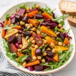 Colorful winter salad Recipe with roasted squash, kale, apples, and pomegranate