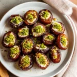 Elegant honey pistachio ricotta stuffed dates on a white serving tray