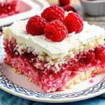 Moist Raspberry Zinger Poke Cake topped with creamy whipped layer and pink coconut