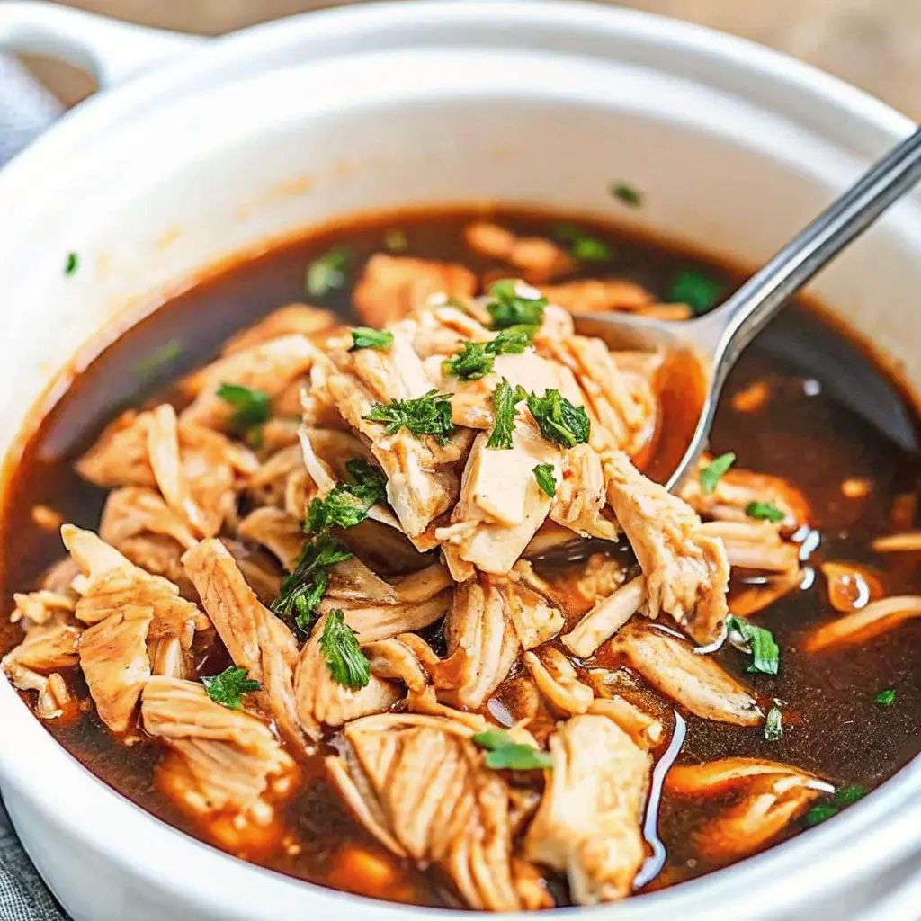 Juicy crock pot bourbon chicken coated in a rich sweet and savory sauce served over fluffy rice
