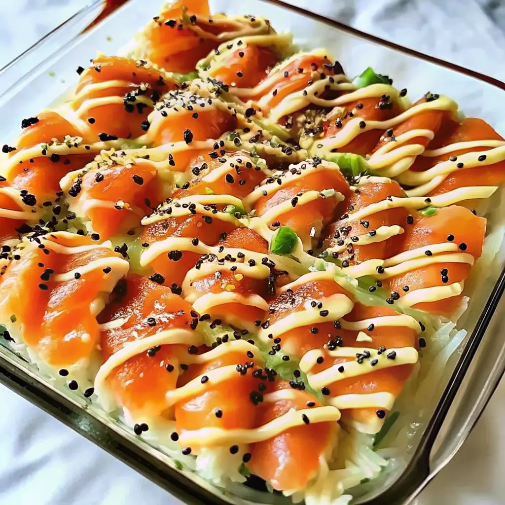 Salmon Sushi Bake in casserole dish with furikake and avocado toppings