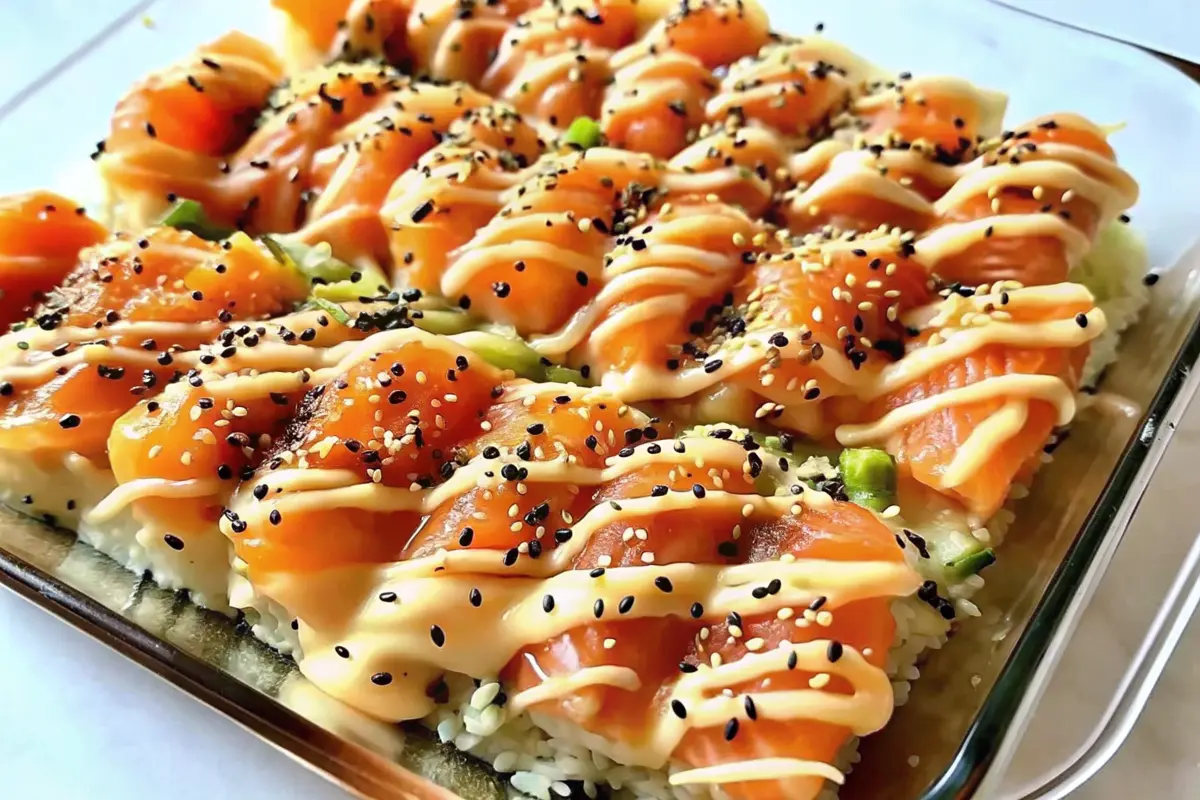 Salmon Sushi Bake in casserole dish with furikake and avocado toppings