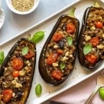 Vegan stuffed eggplant baked with grains, vegetables, and herbs
