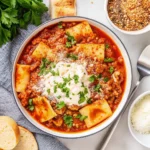 Crockpot lasagna soup in a bowl with a ricotta dollop and fresh basil