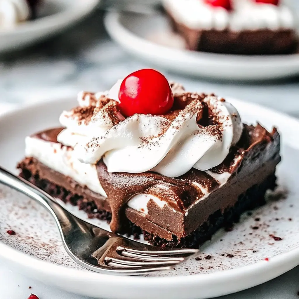 Chocolate Peppermint Pudding Cake dessert topped with whipped cream and candy canes