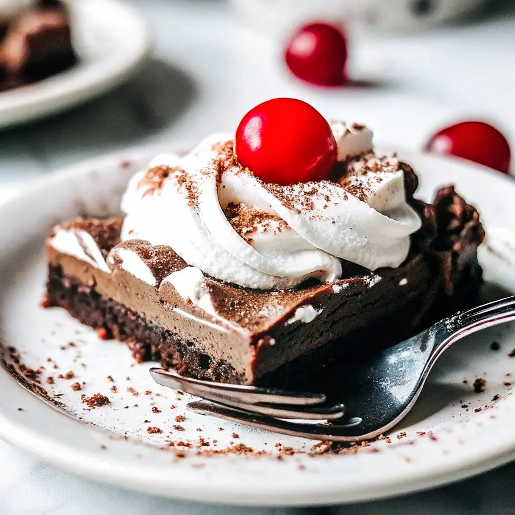 Chocolate Peppermint Pudding Cake dessert topped with whipped cream and candy canes