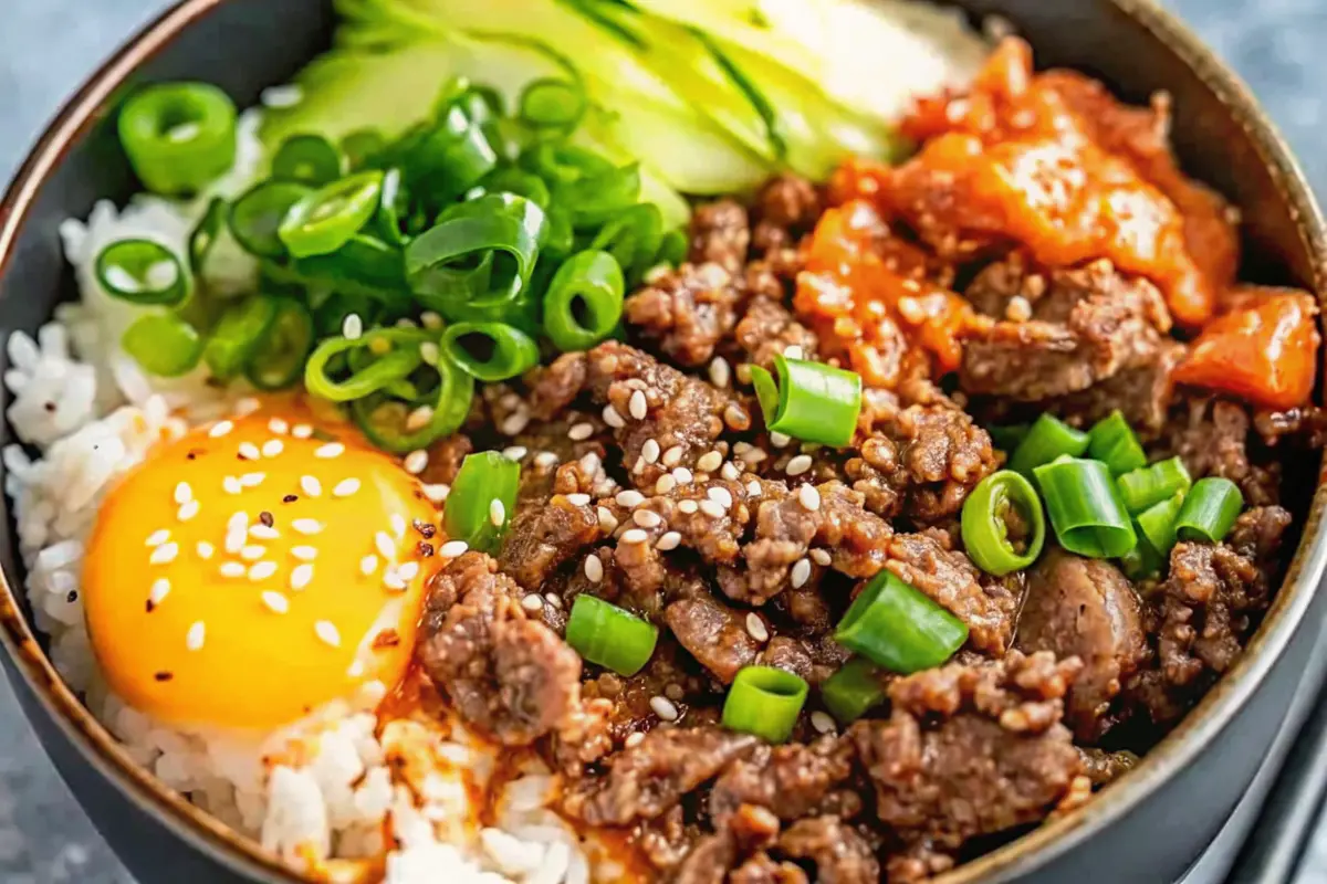 Korean Beef Rice Bowl with saucy beef, rice and colorful toppings in a bowl