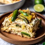 Layered chicken tortilla casserole with melted cheese in a baking dish