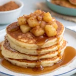 Pancakes with Caramel Apple Compote stacked high and topped with warm cinnamon caramel apples.