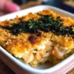 Spicy tuna creamy crab bake in a pan topped with furikake and green onions