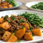 Roasted butternut squash with ground turkey in a rustic baking dish