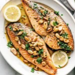 Trout amandine Recipe with brown butter and toasted almonds in a skillet