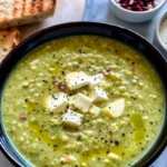 Creamy broccoli feta soup Recipe in a bowl with feta and herbs