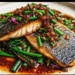 crispy ginger onion fried sea bass recipe plated with sauce