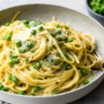 Creamy lemon peas pasta dinner with parmesan and fresh lemon zest