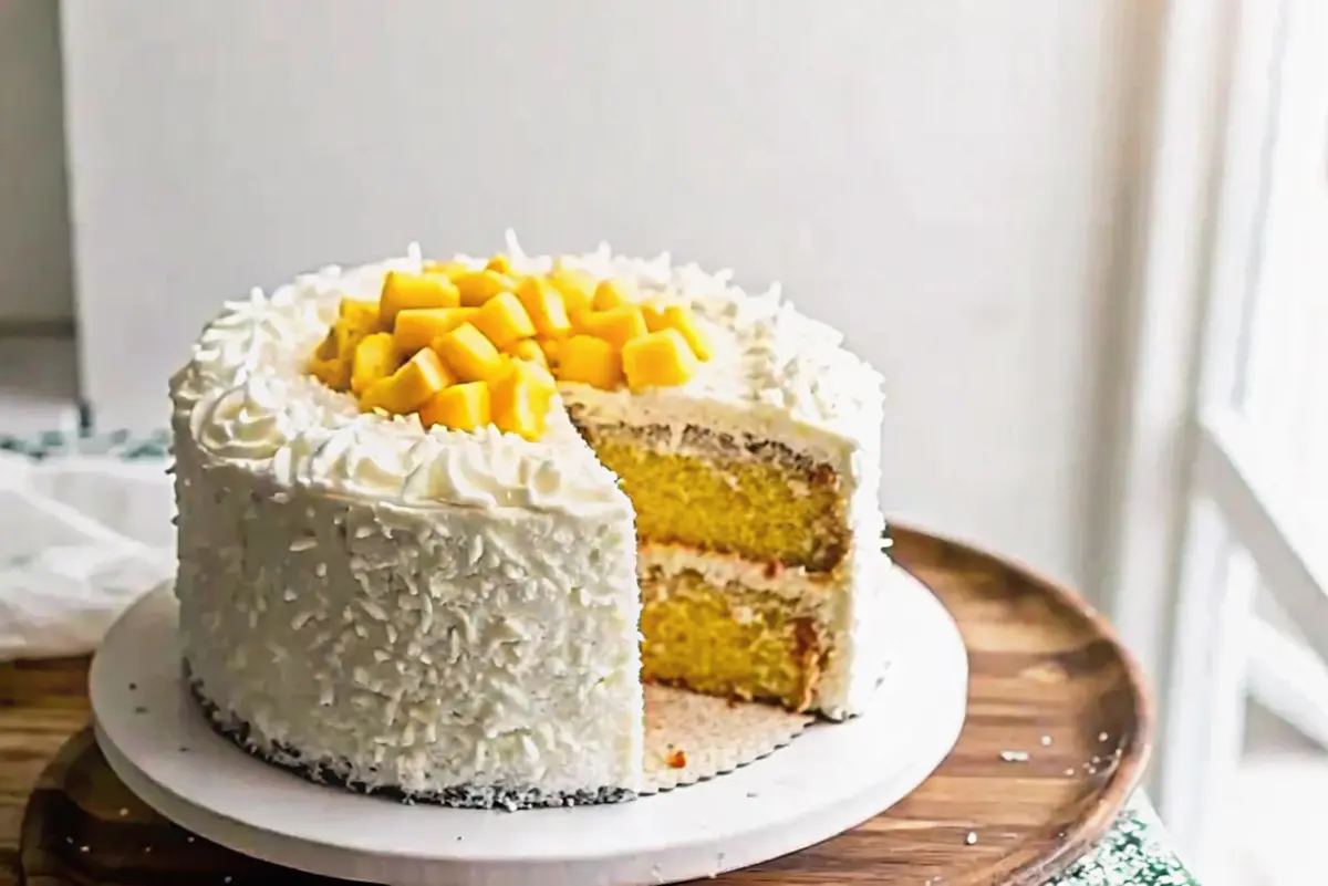 Mango coconut cake topped with fresh mango slices and toasted coconut