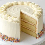 Vanilla cake with buttercream frosting on a cake stand
