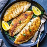 Crispy Air Fryer Tilapia Recipe fillets served with lemon