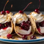 Cherry cheesecake dessert tacos with creamy filling and cherry topping