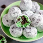 Minty chocolate snowball bites coated in powdered sugar on a festive plate