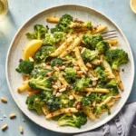 Fresh broccoli salad recipe in a bowl with cranberries, cheddar cheese, and sunflower seeds topped with creamy dressing