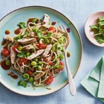 Chicken noodle salad with vegetables and sesame topping