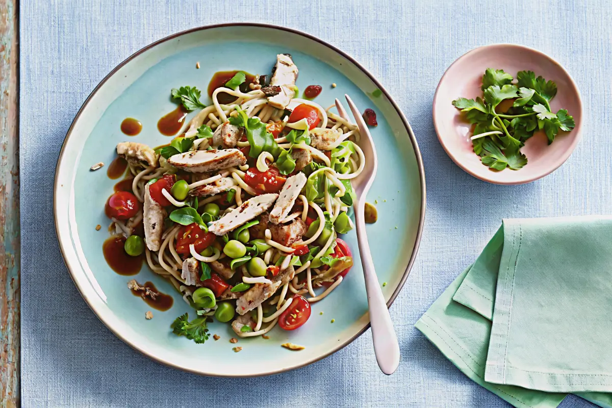 Chicken noodle salad with vegetables and sesame topping