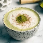 Creamy white chocolate matcha latte topped with frothy milk and matcha powder