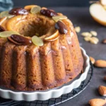 Date pear almond ginger honey cake sliced on a plate