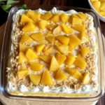 mango tiramisu recipe in glass dish with layers of cream and mango