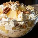 Creamy pineapple pecan cheesecake fluff salad in a serving bowl