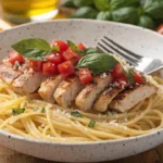Bruschetta Chicken Pasta Recipe served with fresh basil, tomatoes, Parmesan, and grilled chicken.
