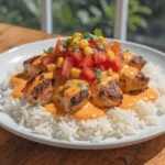 Cheesy Southwest chicken and rice skillet topped with melted cheese and fresh cilantro
