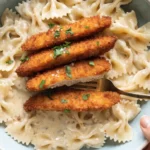 Crispy Parmesan Chicken with Creamy Lemon Pasta served with fresh parsley and lemon wedges