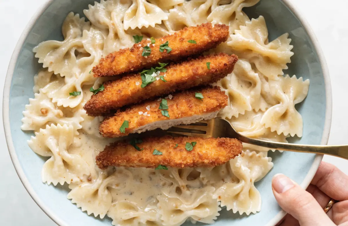 Crispy Parmesan Chicken with Creamy Lemon Pasta served with fresh parsley and lemon wedges