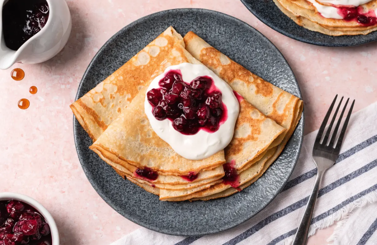 Authentic Swedish pancakes recipe served with lingonberry jam and fresh berries