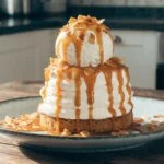 Coconut Cream Sunday Cake topped with toasted coconut and creamy frosting