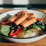 Spicy Chipotle Honey Salmon Rice Salad served with fresh vegetables and lime