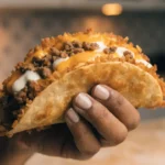 Homemade cheesy gordita crunch taco with beef and cheese
