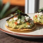 Smashed avocado tostadas recipe with lime and fresh toppings