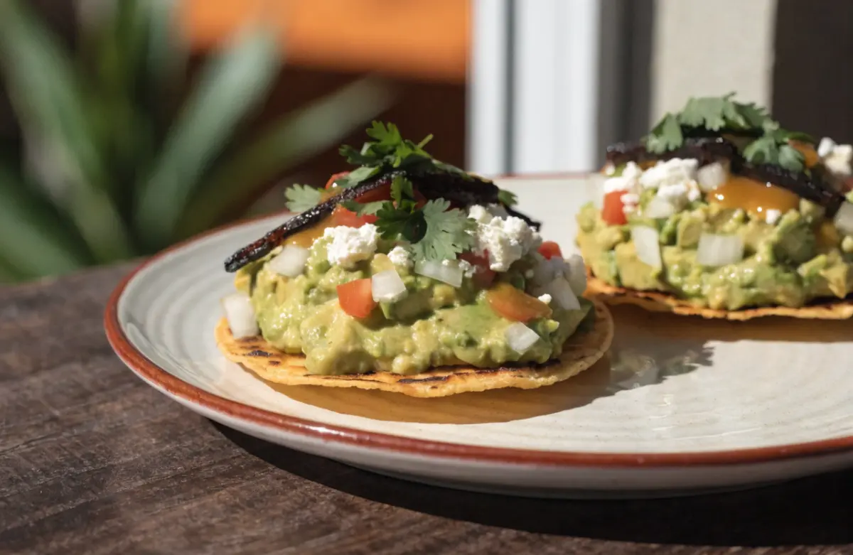 Smashed avocado tostadas recipe with lime and fresh toppings