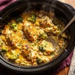Crockpot Creamy Broccoli Cheddar Chicken Rice with melted cheese