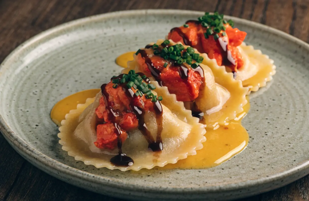 Lobster ravioli with creamy garlic Parmesan sauce garnished with fresh parsley