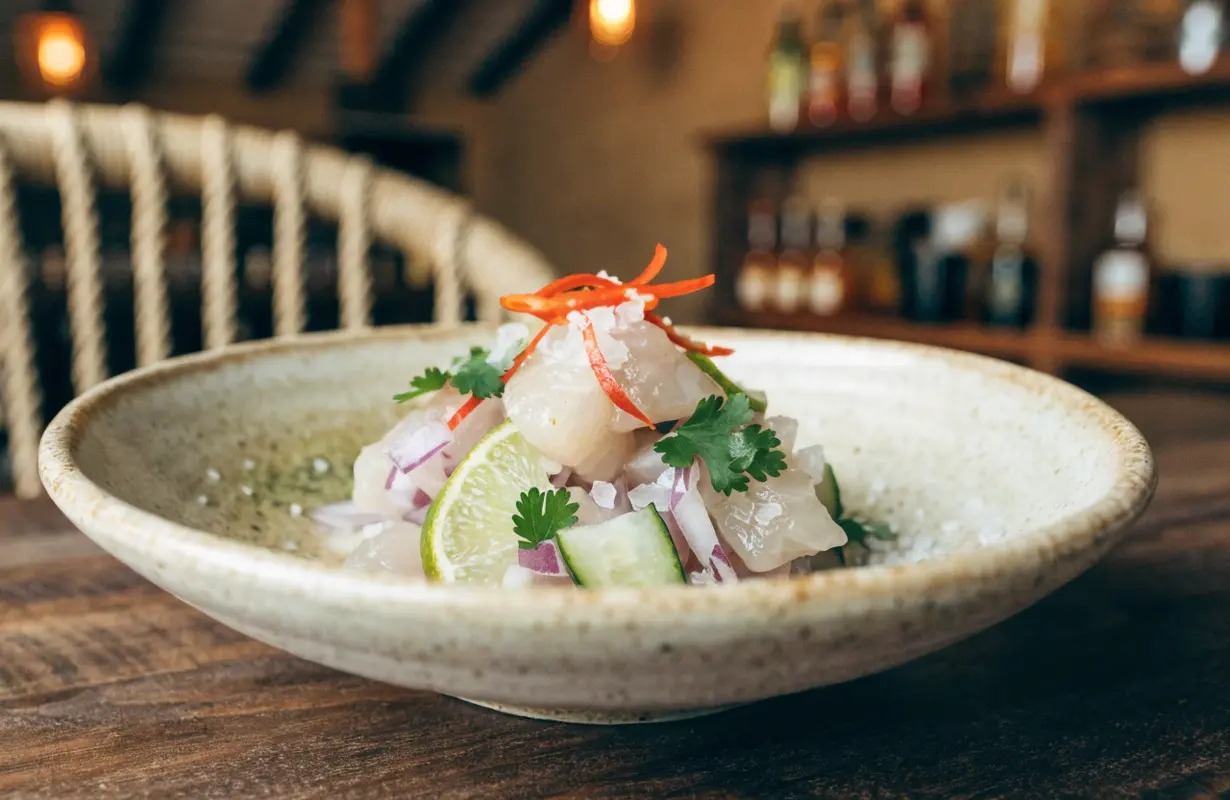 Traditional Peruvian ceviche recipe with fresh fish, lime, red onion, cilantro, sweet potato, and corn